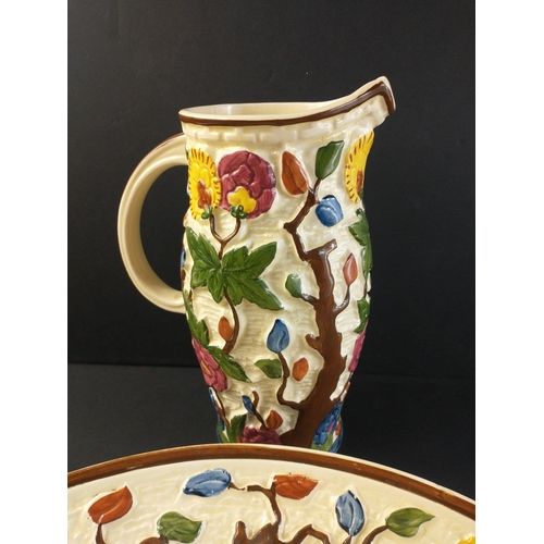 300 - Handpainted Indian tree jug and plate set by H.J.WOOD LTD. Jug stamped 579 and #6941stands 25cm tall... 