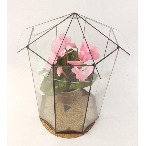 320 - An octagonal glass terrarium with silk cyclamen plant. Stands 35cm tall approx.#324