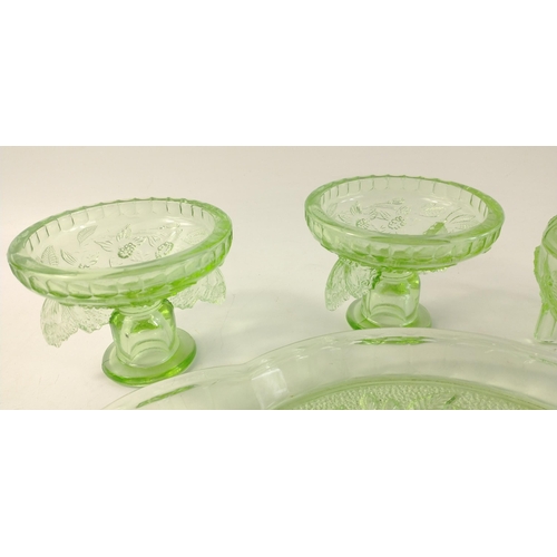 324 - Green glass dressing table set with floral and butterfly embossed design to include a tray (approx 3... 