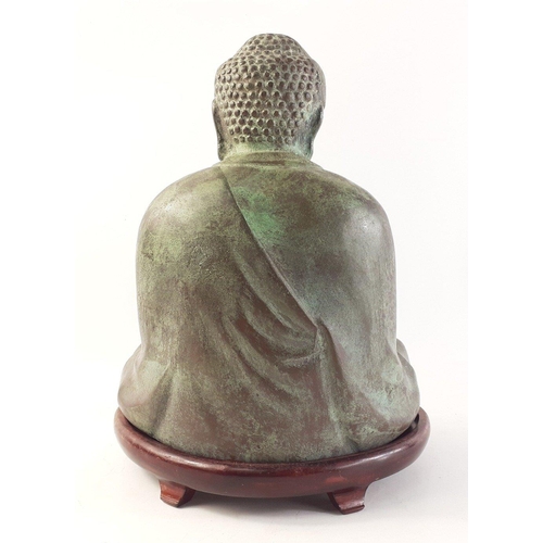 339 - A heavy hollow cast metal BUDDHA on wooden base. Attractively modelled with patinated green finish. ... 