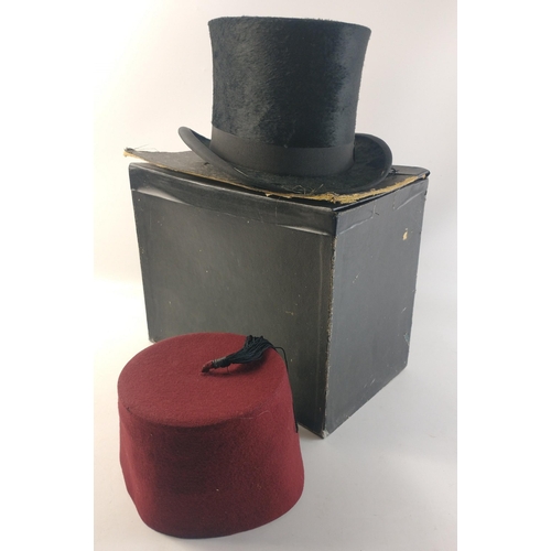 438 - A ladies hunting top hat with veil.  53cm interior measurement approx. In original box.  Also a maro... 