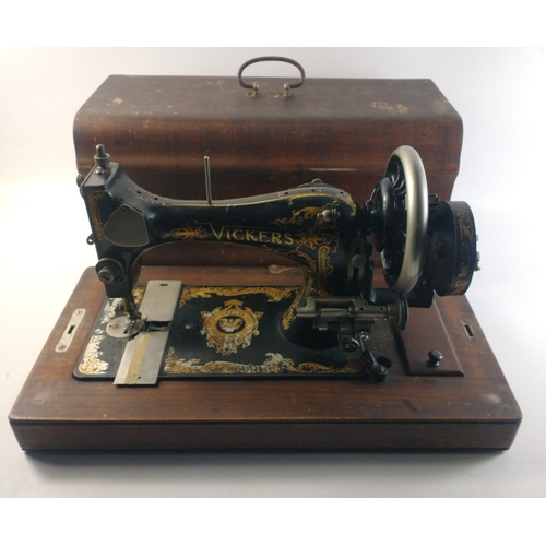 439 - A VICKERS sewing machine in wooden carry case. Modele DeLuxe.  With ornate gilding.  Base measures 5... 