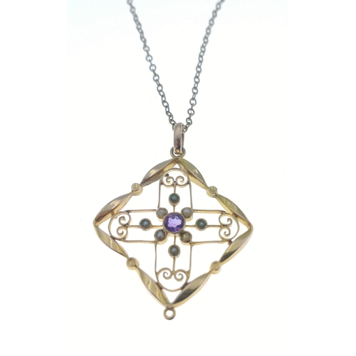 53 - A lovely yellow metal pendant which does not react to a magnet set with a central amethyst and 8 see... 