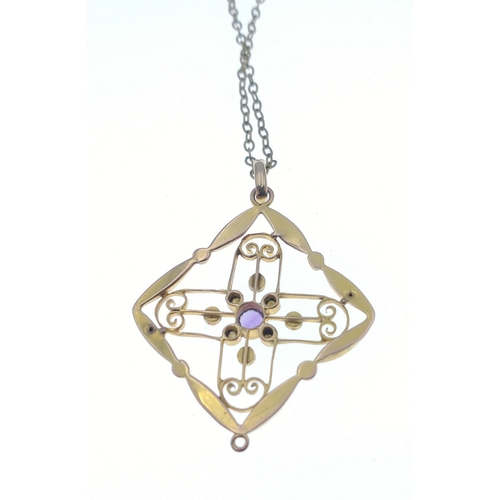 53 - A lovely yellow metal pendant which does not react to a magnet set with a central amethyst and 8 see... 