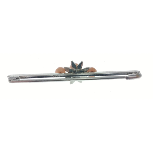 9 - A 9ct stamped white gold bar brooch set with three coral beads, length 42mm approx.  Gross weight 1.... 