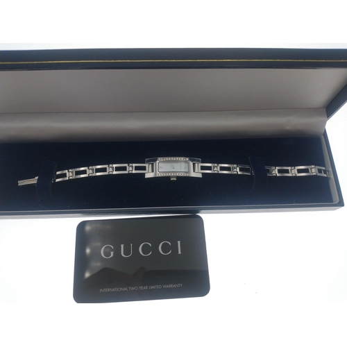 26 - An original GUCCI ladies cocktail watch. Mother of Pearl face with two inset diamonds and a further ... 