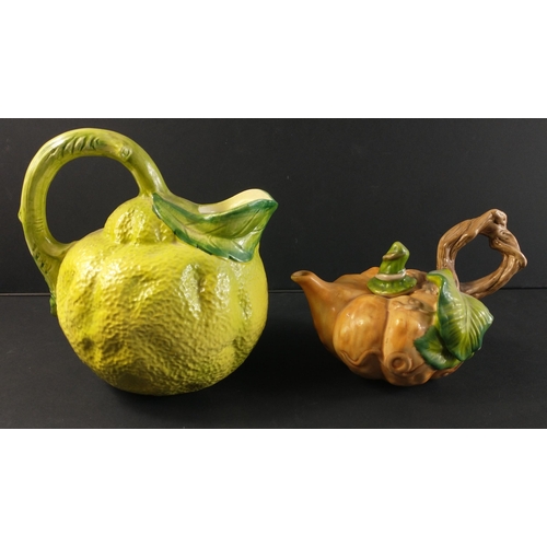 298 - Two novelty fruit based pieces to include pumpkin shaped teapot (approx 12cm tall) and a citrus jug ... 