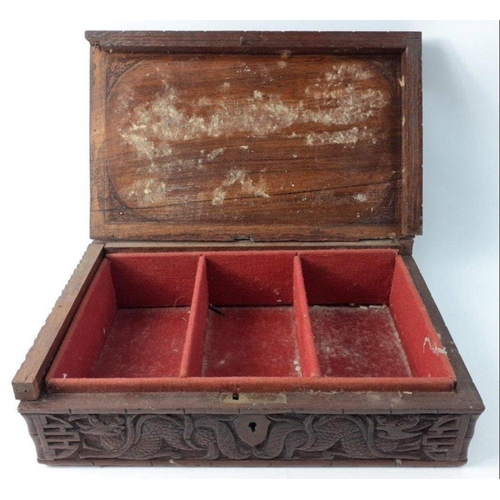 338 - An ANTIQUE Oriental carved wooden box with a fierce 3D dragon on the lid. The lid has become detache... 