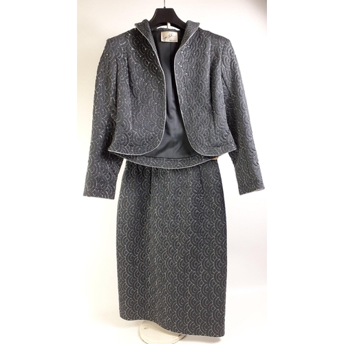 436 - A WAYNE CLARK Aline Marelle suit in black with short quilted jacket and skirt, in black with silver ... 