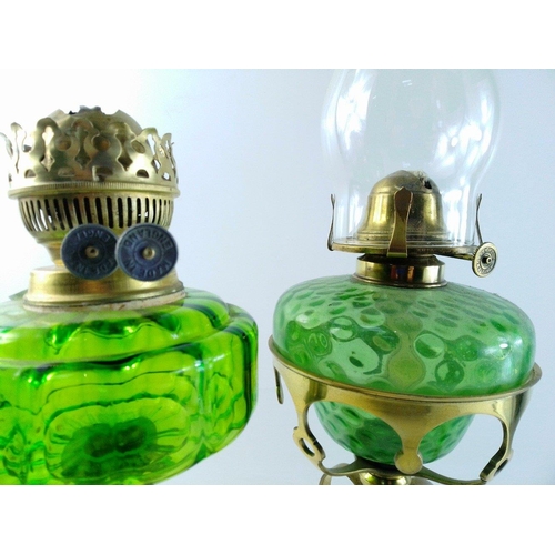 200 - Two oil lamps with green reservoirs. One with ornate antique brass stand standing approx 48cm approx... 