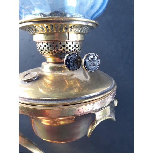 197 - Stunning brass oil burner table lamp with unusual design, chimney and blue glass shade. Burner marke... 