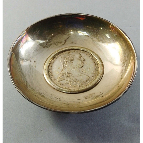 57 - A small unmarked white metal dish with an inset Marie Teresa thaler.  Weight 88.8g approx#62