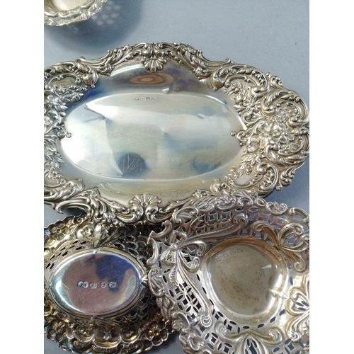 61 - A repousse silver tray (17cm approx), and 3 other small pierced trays.  Combined weight 105g approx#... 