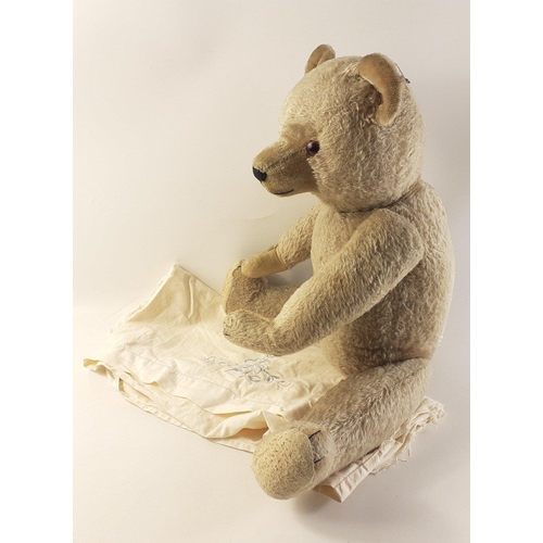 217 - A large and appealing antique teddy bear with indistinct 'Teddy' label. He stands 60cm approx and is... 