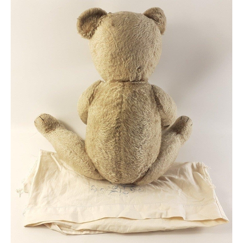 217 - A large and appealing antique teddy bear with indistinct 'Teddy' label. He stands 60cm approx and is... 