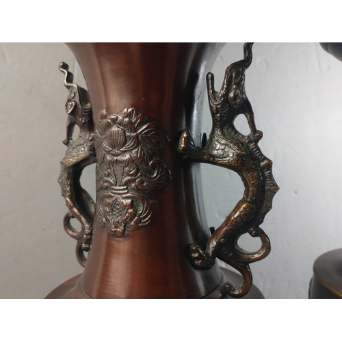 310 - A pair of bronze Oriental vases with dragon handles, each 31cm tall approx.#100