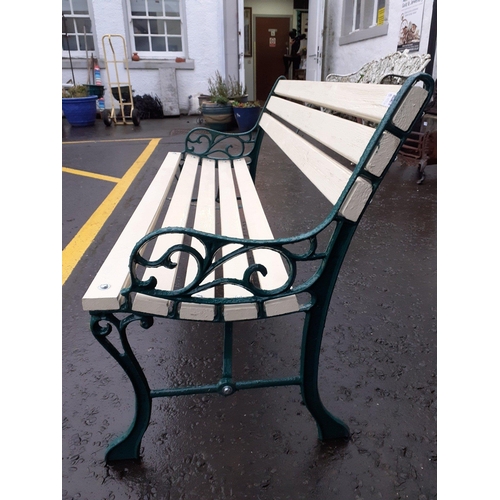 454 - A lovely garden bench with green painted wrought iron ends, recently repainted and ready for the spr... 