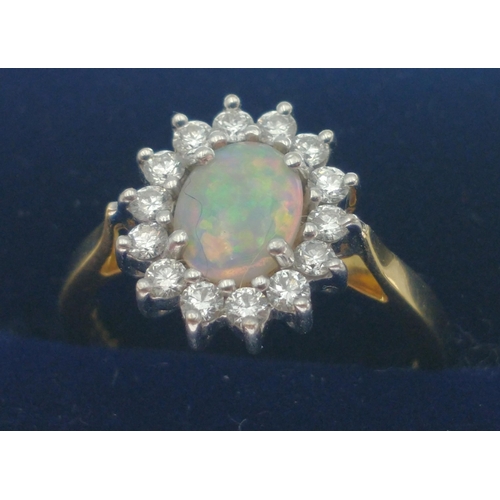 12 - Hand made 18ct yellow and white gold opal and diamond cluster ring set with one centre opal approx 0... 