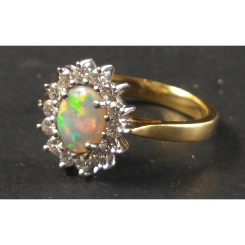 12 - Hand made 18ct yellow and white gold opal and diamond cluster ring set with one centre opal approx 0... 