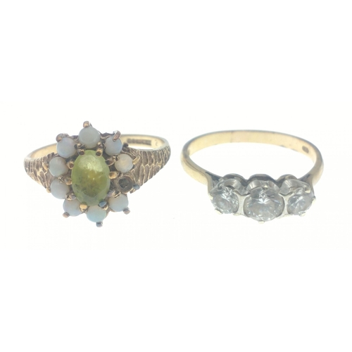 15P - A SUBSTANTIAL 375 stamped yellow gold ring with inset seed opals (one opal missing) and green stone ... 