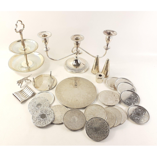 28 - A collection of quality silver plated items to include a cruet set, two sets of coasters, a candelab... 