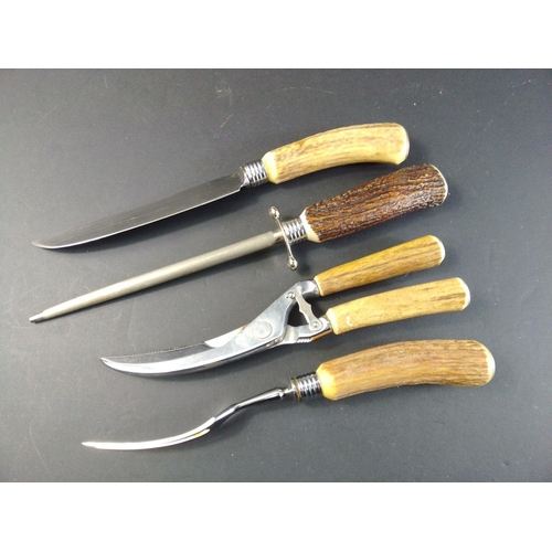 34 - Four horn handled carving set pieces to include kitchen poultry shears.  All in good order.#50