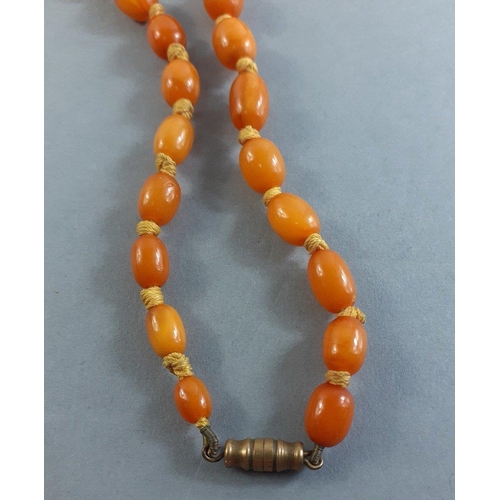 71 - A string of graduated butterscotch amber-style  beads 60cm long approx, weight 29g approx. Note one ... 