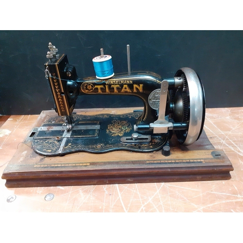 297 - A TITAN Winselmann wooden cased hand crank sewing machine in nice condition#107