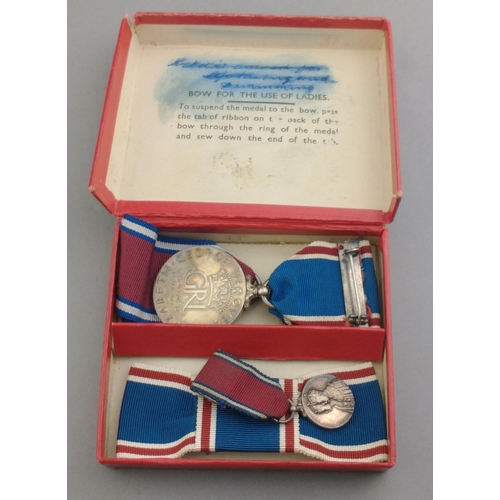 328 - A box containing two 1937 Coronation Medals, a miniature and bow#339