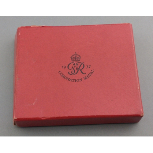 328 - A box containing two 1937 Coronation Medals, a miniature and bow#339