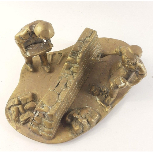 146 - A brass figurine of two men building a drystane dyke.  Base measures approx 30cm.  One figure slight... 