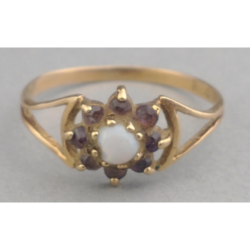 17 - A ladies dress ring (indistinct hallmark looks like 9ct) set with small central opal and surrounded ... 