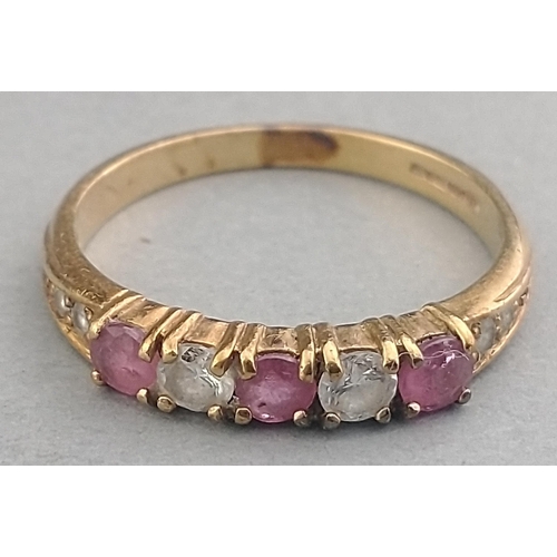 18 - A dress ring stamped 375 set with purple and clear stones.  Size N/O, gross weight 1.5g approx#18... 