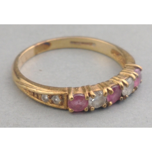 18 - A dress ring stamped 375 set with purple and clear stones.  Size N/O, gross weight 1.5g approx#18... 