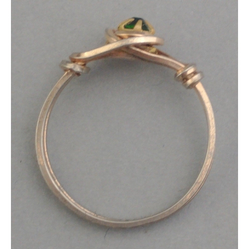 202 - An intricate unmarked yellow metal ring with green centre stone. Size N#201