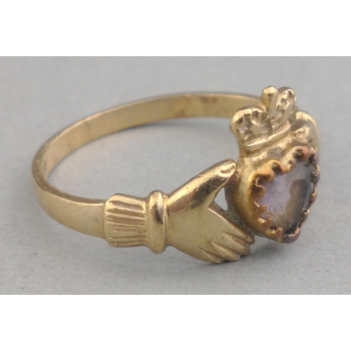 21 - A pretty claddagh ring set with heart-shaped purple stone, hallmarked 9ct/375, size L, gross weight ... 