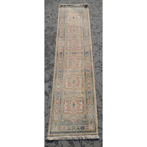 238 - A useful Turkish runner in neutral colours. Size 320cm x 70cm in overall good condition.#237