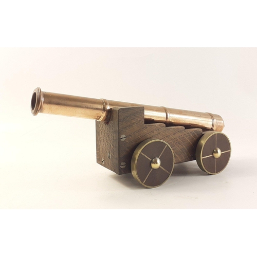 318 - A solid COPPER ornamental cannon mounted on wheels - exceptional quality! - dimensions 25cm long x 8... 