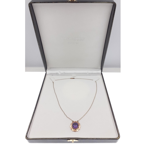 32 - A BEAUTIFUL 9ct stamped pendant and chain with a large central round amethyst - gross weight 4.33g a... 