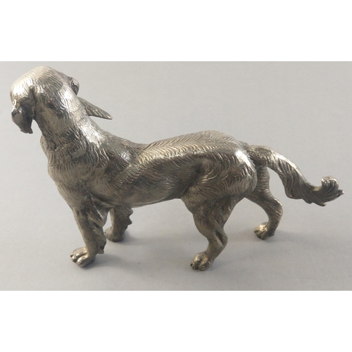 340 - Collectible and well sculpted solid heavy metal model of a retriever gun dog with catch. Stands 16cm... 