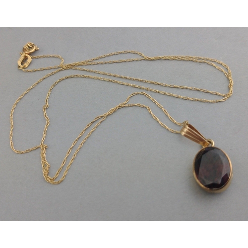 35 - A 375 stamped garnet pendant with a 10k stamped chain, gross weight 1.50g approx#35