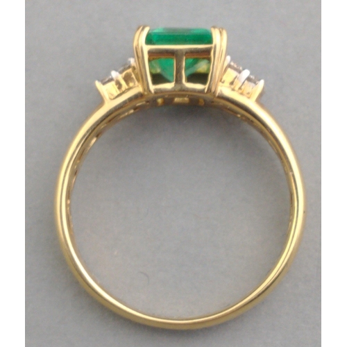 40 - A 750 stamped yellow gold ring with a large square-cut EMERALD supported with 4 diamonds (tested) on... 