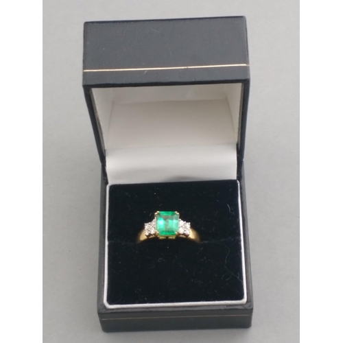 40 - A 750 stamped yellow gold ring with a large square-cut EMERALD supported with 4 diamonds (tested) on... 