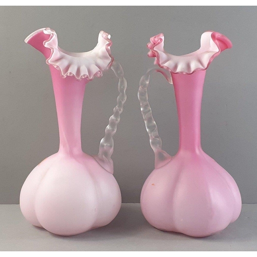 413 - A pair of PRETTY ANTIQUE pink satin glass ewers with beautifully painted floral design - dimensions ... 