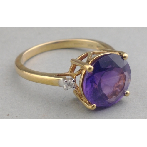 43 - A 10K stamped gold 375 hallmarked ring with 14mm amethyst centre stone and two small diamonds to sho... 