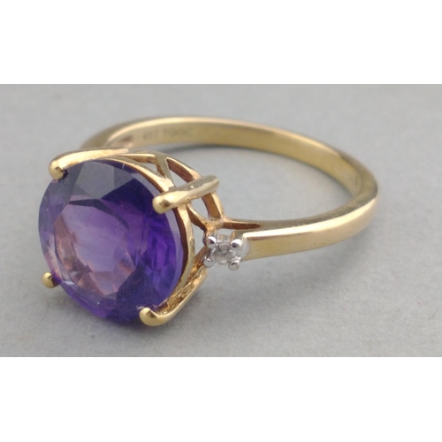 43 - A 10K stamped gold 375 hallmarked ring with 14mm amethyst centre stone and two small diamonds to sho... 