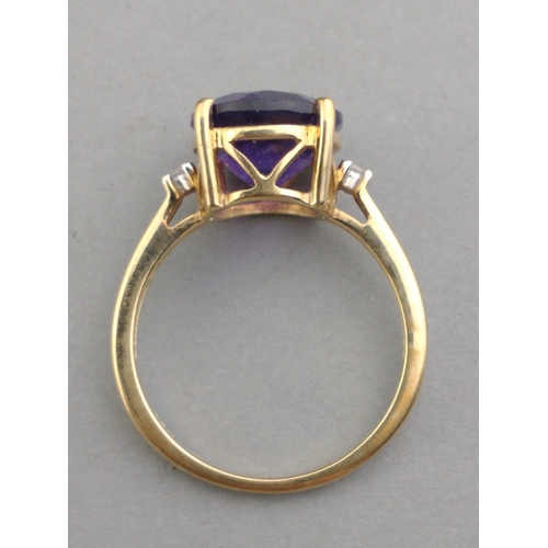 43 - A 10K stamped gold 375 hallmarked ring with 14mm amethyst centre stone and two small diamonds to sho... 