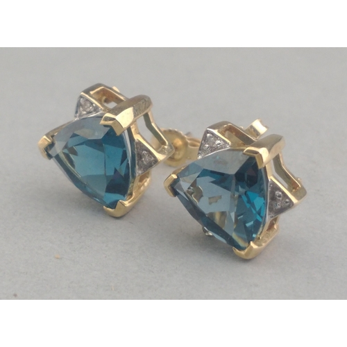 48 - A pair of 375 stamped LARGE JAIPUR INDIAN SAPPHIRE and small diamond (tested) stud earrings in a sta... 