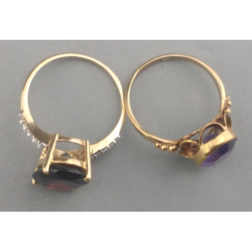 50 - A 375 stamped gold ring with a large AMETHYST stone centred - size M, gross weight  2.21g approx wit... 