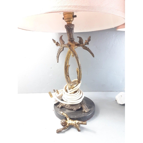 563 - A pair of cherub table lamps with pink satin shades, total height 56cm approx#563